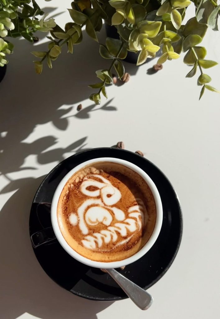 Birds eye view of a cup of coffee, rabbit design on coffee,